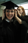 12/17/05 - As the excitement builds, Sociology Graduate Kathleen Murray readies herself to graduate with the assistance of her former roommate Lana Cosby at fall graduation. - Brad Moore