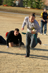 Sophomore D.L. Fruge runs past sophomore Stephen Ellis with the bird during the Young Alums' Turkey Bowl. - Photo by Kyle Kurlick