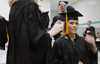 Wendy Bradshaw gets some help with her mortarboard duing fall graduation. - Photo by Kristen Nicole Sayres