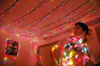 12/5/05 - Senior Chris Hayden admires his brightly decorated dorm room during the holidays.