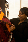 1/26/06 - Senior Kimberly Brown, of New Orleans, one of 11 students who transferred to Union in the fall because of Hurricane Katrina, selects a quilt made by Kindred Spirits Quilters, from Hydewood Park Baptist Church in North Plainfield, N.J.