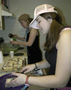 Resident Assistant Kristin Jennings cuts up some cake while Katrina Parker prepares some green punch during a dorm room birthday party. - Photo by Stephanny Rodriguez