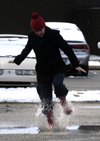 Lindsey Abell creates some puddle fun as the ice begins to melt. - Photo by Stephanny Rodriguez