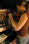 Alum Ashley Murphy works with Level Grounds to prepare coffee for students at the Homecoming Coffeehouse. - Photo by Brad Moore