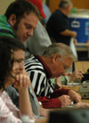 Don Richard, associate professor of mathematics, keeps the official scorebook during home basketball games. - Photo by Heather Phillips