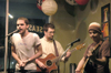 Aaron Hardin steps in to play guitar with Aaron Shepherd and Andy Kelly, collected known as the Uncollected Prose, during a Feb. 25 concert at Seasons Coffee and Cafe, which often hosts local talent. - Photo by Stephanny Rodriguez