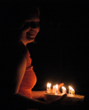 03/9/06 - Katrina Parker brings in a flaming cake for Kristin Jenning's birthday.