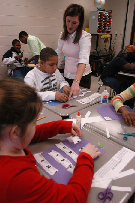 <em>C&C Photo Story:</em> Tricia Currin helps with a project assigned to the children during one of their classes. She helps explain how to do the project correctly. Currin likes helping and interacting with the children. She especially likes talking and hanging out with them outside of class.
