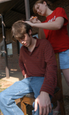 04/2/06 - Roberson cuts the hair of Richard Hart, Christian studies major. Roberson cuts the hair of her friends
and fellow students for free.