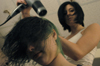 04/2/06 - Sophomore Erin Veneman blow-dries fellow sophomore Ruthann Pike's hair in a dormitory room.