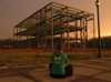 Senior Tricia Currin, elementry education major, takes a moment to look at the progress made on
White Hall. She enjoyed the picturesque sunset on campus right before the storms on April 8. - Photo by Heather Phillips
