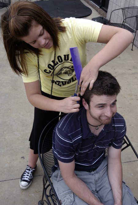 Sophomore Sally Goulooze trims Chris Rigney's hair
outside of the Barefoot Student Union while enjoying the nice spring weather.