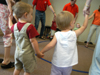 Students and parents participate in a game in the Kindermusik program at the Community Music Center. - Photo by Heather Phillips