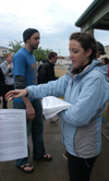 Jennifer Tharp hands out information about what the night ahead holds for the Invisible Children Global Night Commuters.  The Commute took place at the Farmer's Market in downtown Jackson to raise awareness of the genocide occurring in Uganda and Sudan. - Photo by Heather Phillips