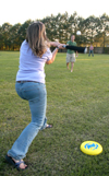 Heather Phillips (batting) takes a swing at Landon Preston's pitch during a baseball game with classmates at President Dockery's house during Happy Trails, a farewell event for graduating seniors sponsored by Young Alums. - Photo by Brad Moore