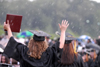 Kathleen Lokey (left), social work graduate, enjoyed the rain that fell during spring graduation. - Photo by Kathleen Murray