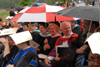 Members of the Union University faculty watch as their students receive degrees during a sudden rainstorm on the Great Lawn. - Photo by Morris Abernathy
