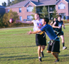 Senior SAE Josh Gilmore (white) laterals the ball to allude a tackle in an intramural flag football game between SAE and LXA. - Photo by Justin Veneman