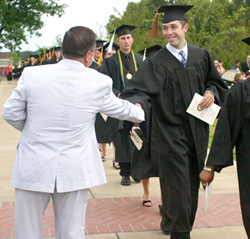 5/20/2006 - Associate Vice President for University Relations and Alumni Services Gary Williams greets the newest Union graduates of May 2006. (ID: 5476)