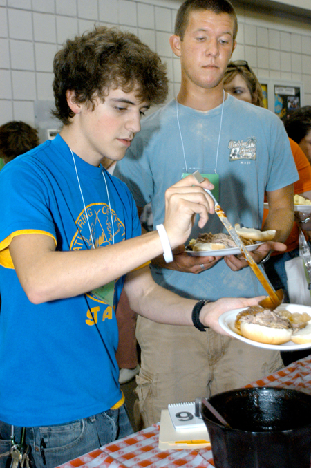 Matt Elia and Daniel Cathey grab some barbeque during New Student Orientation. 