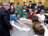 08/29/05 - The crowd goes wild as they watch the intense game of spoon hockey between Cassie Harris & Lydia Livingston during the Ice Cream Social at New Student Orientation.