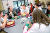Linn Stranak, chair of the physical education, wellness and sport department, talks with freshmen  during a New Student Orientation dinner. - Photo by Kristen Nicole Sayres