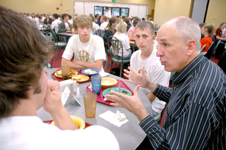 Steve Beverly, acting chair of communication arts, talks with incoming communication arts students during a New Student Orientation dinner.