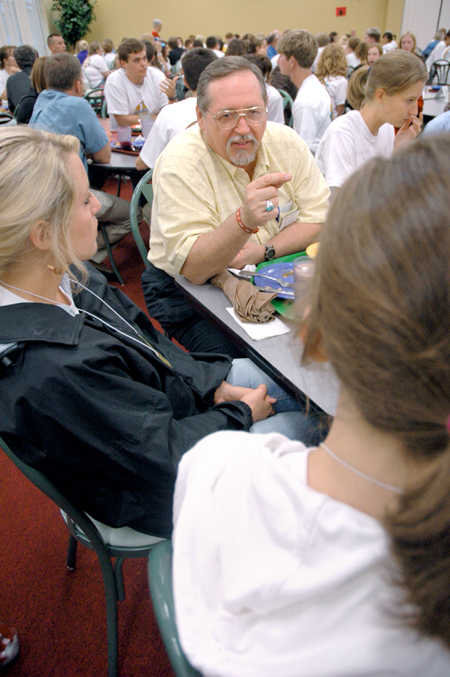 Terry Weaver, associate professor of special education, talks with incoming education students during a New Student Orientation dinner.