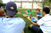 09/14/05 - Left to Right: Claire Yates (far left), Jordan Atwell (backwards hat), Micah Whitaker, Steven Beckham, and Mike McPherson pass around various fruits for a game of Musical Fruit during a LIFE Group meeting. - Brad Moore