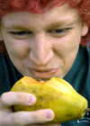 09/14/05 - Steven Beckham takes a bite of a papaya for a game of Musical Fruit during a LIFE Group meeting. - Brad Moore