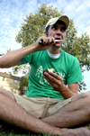 09/14/05 - LIFE Group leader Micah Whitaker takes a bite of an avacado for a game of Musical Fruit during a LIFE Group meeting. - Brad Moore