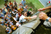 7/16/02 - Barbara Bishop, a member of the youth group at First Baptist, Pochahontas, Ark., gets assistance from other campers in climbing a six-foot wall in another trust-building exercise.
