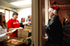 12/13/05 - Anna Sanders, Dan Dresselhaus, Lauren Elledge and Dustin Curtis serve Kyle Rains some finals pizza in the McAfee commons.