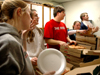 12/13/05 - McAfee residence assistants Anna Sanders, Dan Dresselhaus, Lauren Elledge and Dustin Curtis pass out pizza to hungry students during food for finals.