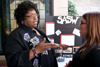 Roslyn Wilson, associate professor of social work and coordinator of Social Work Awareness Day,
consults with senior Lindsay Lawrence in front of the SASW booth in the Student Union Building. - Photo by Kyle Kurlick