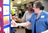 Sandra Allen, director of payroll services, learns about a local social work initiative during Social Work Awareness Day. - Photo by Kyle Kurlick