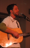Joe Garner performs playing both guitar and harmonica at a concert held in Union's student lounge.  - Photo by Kristen Nicole Sayres