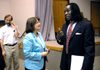 Luther Mercer of the National Institute for Law and Equity speaks with Mary Anne Poe, chair of the social work department, after the annual Social Justice Symposium. - Photo by Kristen Nicole Sayres