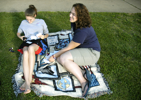 Angela White and Kristin Jennings relax in the grass in McAfee Complex while preparing for finals week.