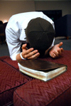 Matt Elia prays for the Invisible Children of Uganda during a prayer vigil in the student lounge. - Photo by Kristen Nicole Sayres