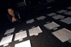 Katie Stephens prays over letters to congressmen for the Invisible Children of Uganda during a prayer vigil in the student lounge. - Photo by Kristen Nicole Sayres