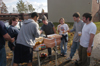 Sophomore James Harvey (center) and his roommate pooled $100 of their own money to buy doughnuts, orange juice, duct tape & plastic to help meet students' immediate needs on Sunday morning. - Photo by Jim Veneman