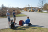 Temporarily-displaced students watch power line repairs as they wait for shuttle buses to donated rooms at the nearby Jameson Inn. - Photo by Jim Veneman