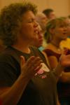 Parents and new students lift up their hands in praise while singing worship songs during the family chapel service the first night of New Student Orientation. - Photo by Stephanie Schroeder
