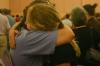 After reading a card given to her, Joy Harris received many hugs and tears from her family as she said good-bye to them after the family chapel service during New Student Orientation. - Photo by Stephanie Schroeder