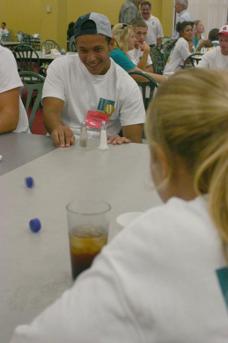 Alessandro Oliveira, from Brazil, plays a game with bottle caps with Abigail Williams, from Crossvile, Tenn., at the ice cream social during New Student Orientation. 