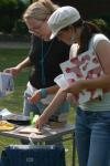 09/8/06 - Jill Brown and Kelly Harris check out items for sale at a yard sale set up by fellow students in front of McAfee commons. 