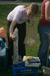 09/8/06 - Junior Emily Watlington checks out a poster and other items for sale at a yard sale set up by students in front of McAfee commons.