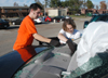Sophomore Brennan Uthe from Grand Rapids, MI and junior Megan Fuller from Clarksville, TN help a friend clean-up the damage to her car as a result of the tornado. - Photo by Jim Veneman