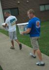 Senior Joel Polk and Matt Brunet, director of wellness services, assist freshmen as they move in during New Student Orientation. - Photo by Matthew Diggs